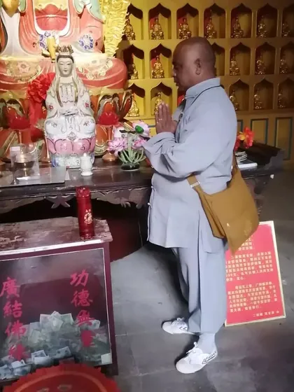 A moment of prayer before a Guanyin deity in a Songshan temple. These are rare glimpses into the spiritual life within the monastery walls.
