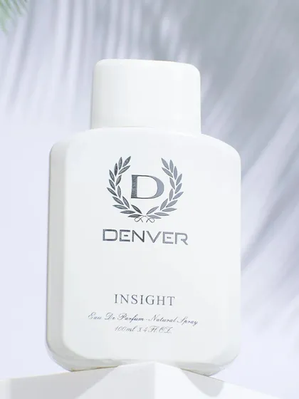 A clean, high-key hero shot of a white perfume bottle. This minimalist style is perfect for e-commerce listings and focuses all attention on the product's design.