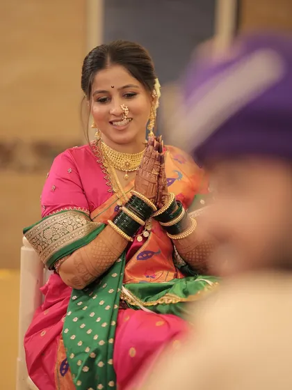 A candid shot of the bride smiling at her groom during the ceremony.