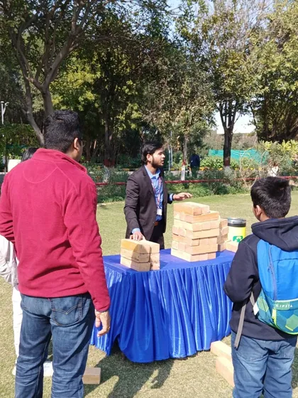 My staff explaining the rules of Giant Jenga to guests at an outdoor family day event. I can provide attendants to manage the games and assist your guests.