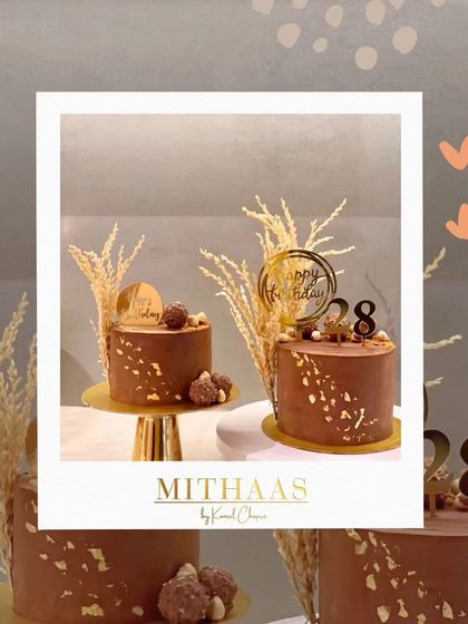 A duo of rustic-chic chocolate birthday cakes. Decorated with gold leaf and dried wheat stalks, these cakes are perfect for a sophisticated and understated celebration.