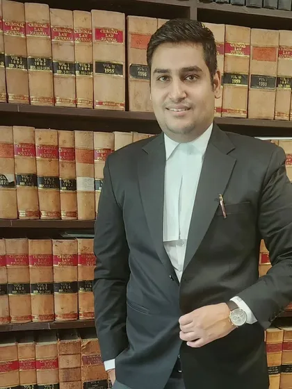 A portrait in front of my law library. Having access to extensive legal resources is essential for providing well-researched and effective representation.