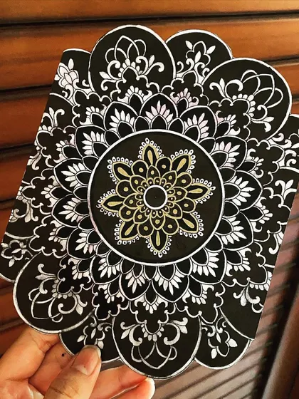 This black and white mandala has a unique, flower-like shape. I added a small touch of gold in the center to draw the eye and add a hint of elegance.