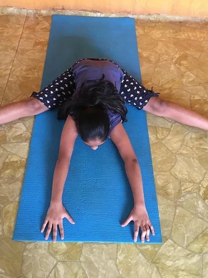 The same student, demonstrating consistent form in Upavistha Konasana.