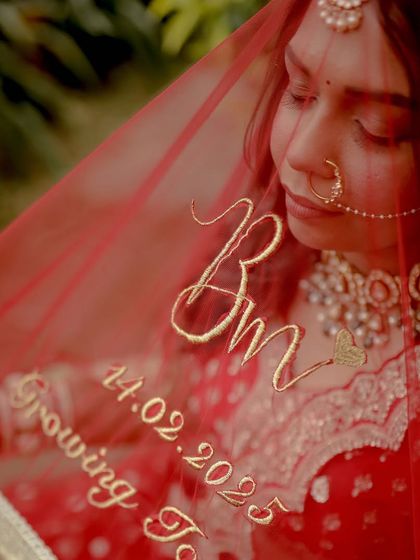 A close-up of the bride's personalized veil, a beautiful and unique detail. The makeup is kept soft and romantic to complement this special touch.