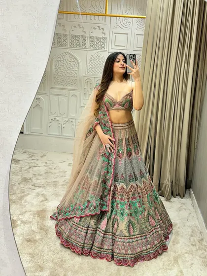 I call this my 'Unicorn Lehenga' and you can see why. The unique blend of pastel grey, pink, and green threadwork creates a magical, one of a kind look for a bride who wants something different. This designer piece is available to rent or buy.