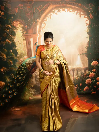 A full-length portrait showcasing the beautiful drape and fall of a traditional gold silk saree, perfect for a maternity session.