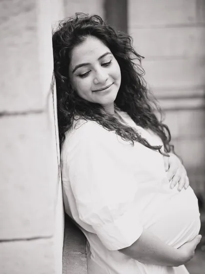 This is a simple, timeless black and white portrait of an expecting mother. My goal here was to capture the peaceful, inward-looking joy that defines pregnancy, creating a classic image she can cherish forever.