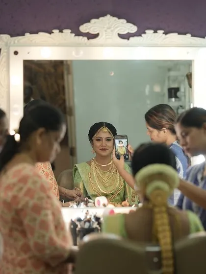 A behind-the-scenes shot of my bride Harina getting ready in the studio. This image captures the full bridal setup, with my team ensuring every detail is perfect for her Muhurtham.