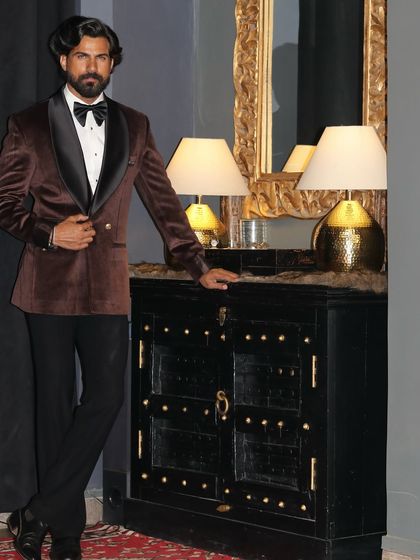 A full-length pose in the brown velvet tuxedo, a testament to its elegant and commanding presence.