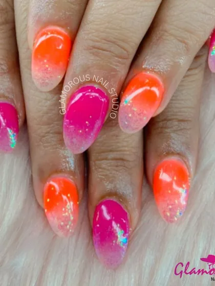 Turn up the volume with this electrifying neon ombré. We blended a hot pink into a bright orange, with a touch of glitter at the tips for extra sparkle. This look is all about being bold, bright, and ready to party.