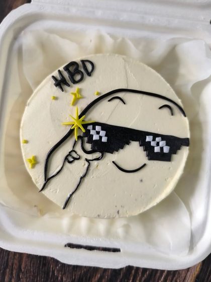 Too cool to eat, this bento cake captures the classic "thug life" meme with pixelated sunglasses and a confident smile. It's a fun, modern design for a birthday celebration.