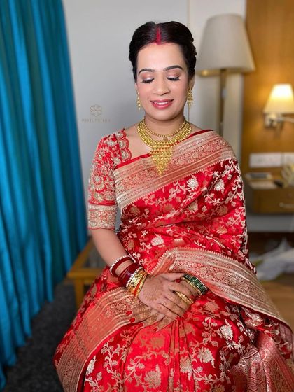 The bride's happy and serene expression says it all. Her hair is elegantly tied back, letting her beautiful features and outfit shine.