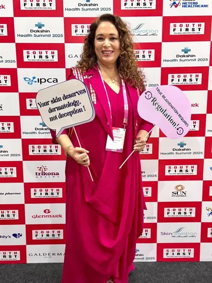 At the Dakshin Health Summit 2025, holding signs that reflect my core beliefs: "Your skin deserves dermatology, not deception" and "True rejuvenation requires regulation."