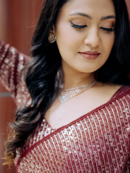 A detailed shot of the eye makeup, featuring a sharp winged liner and neutral tones.
