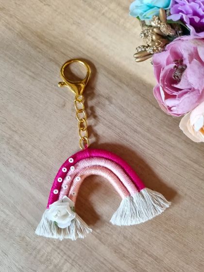 This macrame rainbow keychain in shades of pink is a perfect gift for your loved ones. Adorned with sequins and a tiny rose, it’s a little reminder to find the magic in every day.