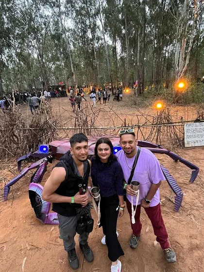 Posing with friends at a festival out in the woods. These events are as much about the community and the people you meet as they are about the music and art.