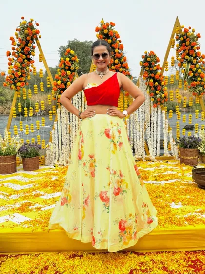 Posing in my vibrant Haldi outfit against the stunning marigold decor.