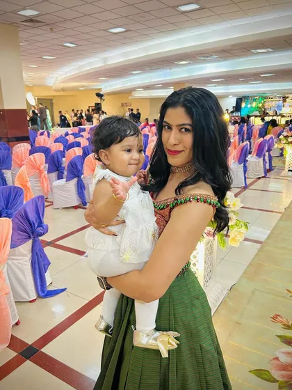 A heartwarming transformation. We took our client's mother's traditional saree and repurposed it into this stylish off-shoulder crop top and pleated lehenga skirt. It’s a beautiful way to honor family heritage while creating a new, modern look.