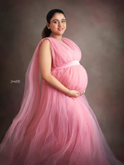 A simple, beautiful portrait of this stunning mama. The soft pink gown and the classic painted backdrop create a timeless and artistic maternity photograph.