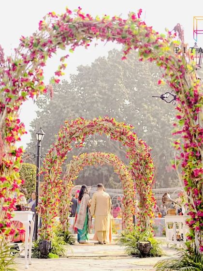 A beautiful floral archway made of bougainvillea, perfect for a daytime garden party or Mehendi ceremony.
