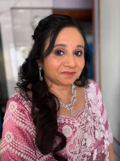 A classic, elegant look for a mature client. The makeup is soft and enhances her features, with a dusty rose lip color.