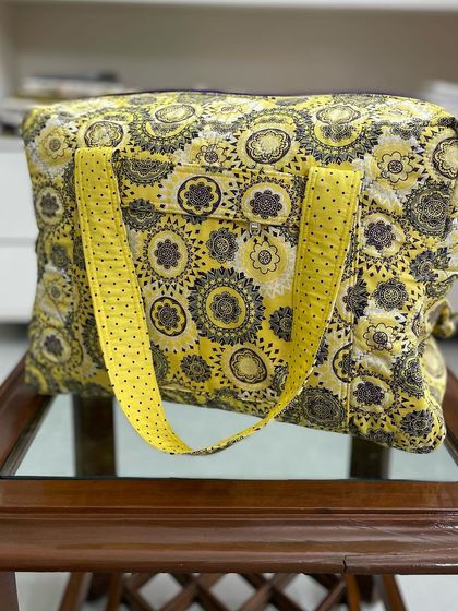 A side view of the travel bag, highlighting its boxy shape and generous capacity for weekend trips.