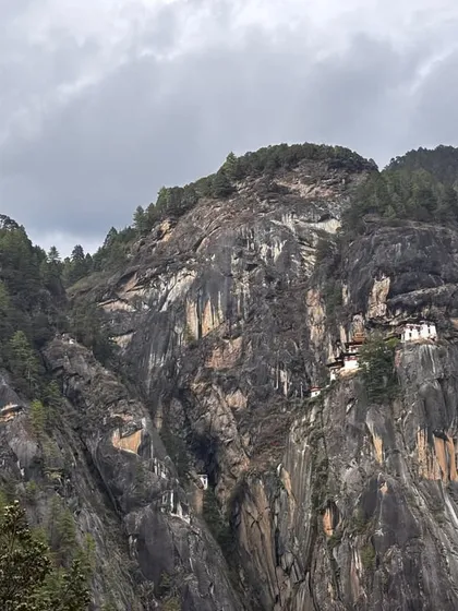 This is the world famous Tiger’s Nest Monastery in Bhutan, seen from the trail. The monastery clings to a sheer cliff face, and the trek to reach it is the main highlight of my 7-day all-inclusive Bhutan trip. The view itself is worth the journey.