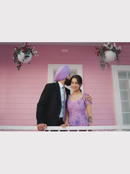 A sweet forehead kiss on the balcony of our dreamy pink house set. This location is perfect for creating light, airy, and romantic pre-wedding photos.