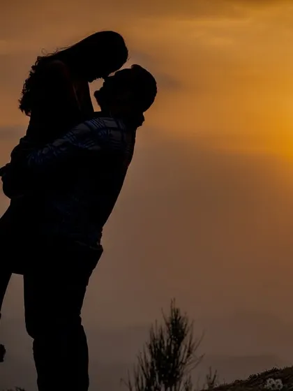 A perfect silhouette against the golden hour sun, capturing the pure romance and intimacy of a couple's connection. I live for these magical sunset moments in the hills.