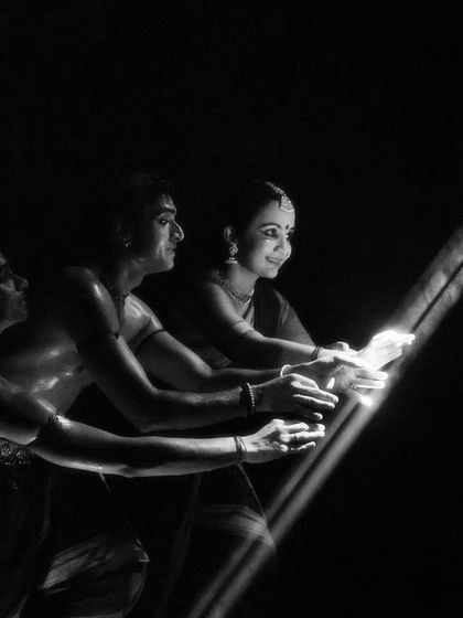 A black and white still from 'Nagamandala', using a single beam of light to create a path. This visual metaphor is a powerful tool in our stagecraft.