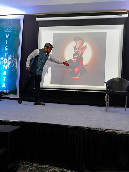 During a guest lecture, I enjoy diving deep into the specifics of my art style. Here, I'm on stage explaining the techniques behind one of my digital caricatures, showing students how exaggeration and form come together to create a compelling piece.