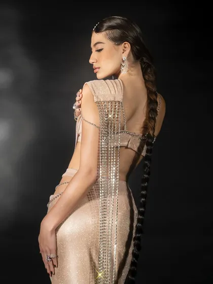 A back-profile shot showcasing the cascading chain detail on a Nikhil Thampi creation. This is crucial for lookbooks to show the garment from all angles, highlighting unique design elements.
