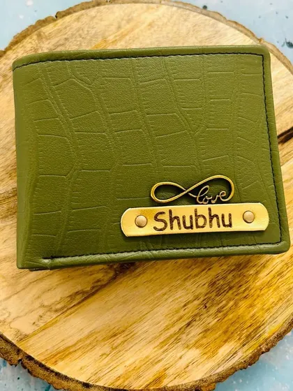 An olive green croc-textured wallet featuring a gold nameplate and an infinity-love charm. This color is a unique and stylish choice.