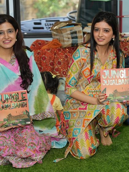 A close-up of our co-founders with the 'Jungle Jugalbandi' book on the 'Sound Space on Wheels' bus.