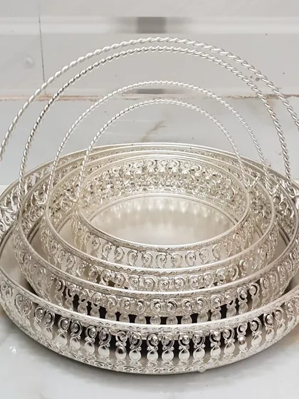 This set of nesting German silver trays is both practical and beautiful. The intricate latticework and sturdy handles make them perfect for serving guests or as a base for a decorative arrangement.