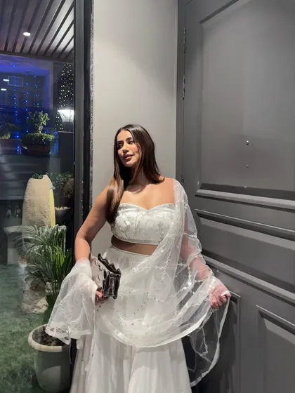 Capturing the Bollywood moment in a white sequined lehenga, a timeless choice for any grand Indian celebration.
