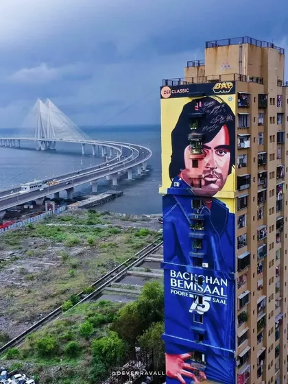 Another view of the towering Amitabh Bachchan mural, this time with the Bandra-Worli Sea Link perfectly framed beside it. It highlights how street art interacts with the city's famous architecture.