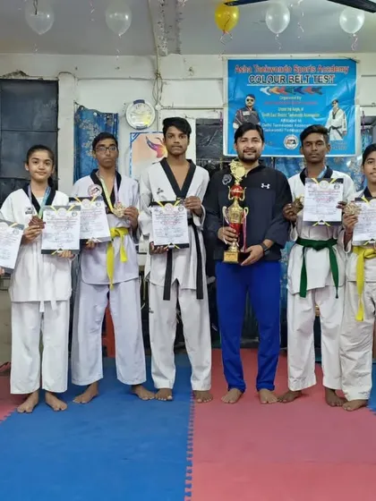 Our winners from the Open National Taekwondo Championship, holding their well-earned certificates, medals, and trophies.