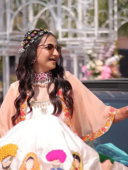 Making a grand entrance at her Haldi carnival. The bride's fun-loving personality shines through, and her makeup is designed to be bright and long-lasting.