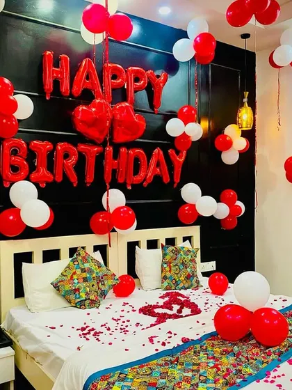 A clean and bright look for a birthday bedroom. The red and white balloons are arranged neatly against a dark headboard, making the "Happy Birthday" message pop.