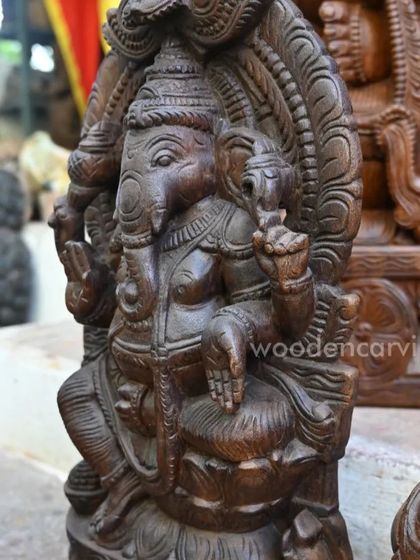 A close-up of a seated Ganesha idol, focusing on the calm and meditative posture.