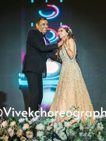 A touching father-daughter moment on stage. We choreograph these emotional performances to capture the special bond between family members.