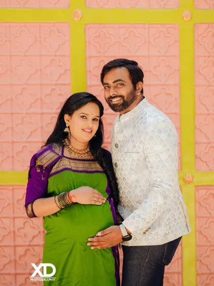 A smiling couple posing in a traditional setting, their joy and connection evident.