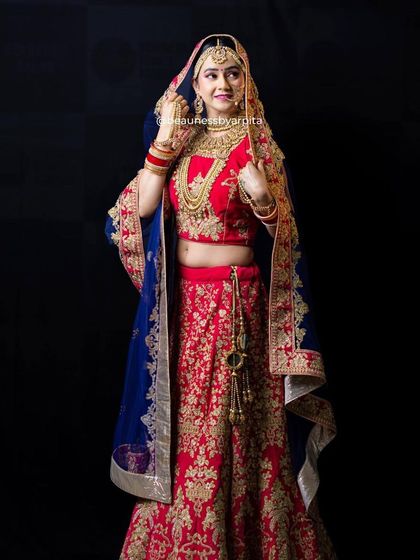 This stunning red lehenga paired with a royal blue velvet dupatta offers a unique and regal combination. We love helping brides find a look that is both traditional and personal.
