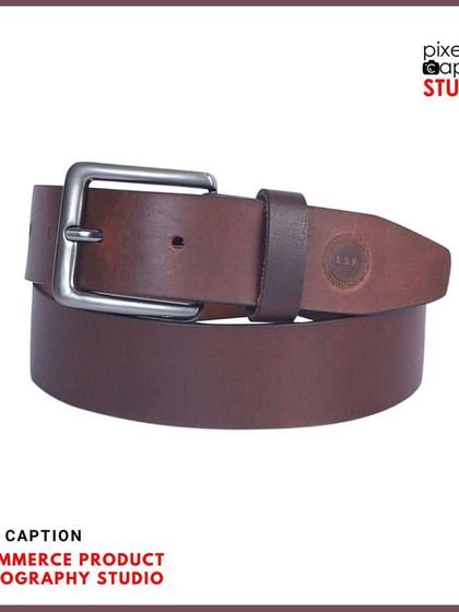 A professionally shot brown leather belt, coiled to show both the buckle and the leather texture.