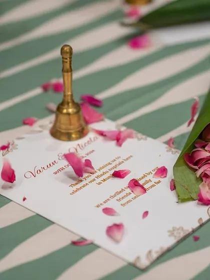 For the 'Kel Baradari' wedding, guests were given cones made of banana leaves filled with fresh rose petals to shower the couple. A small bell was placed with the program card, inviting guests to ring in the celebration.