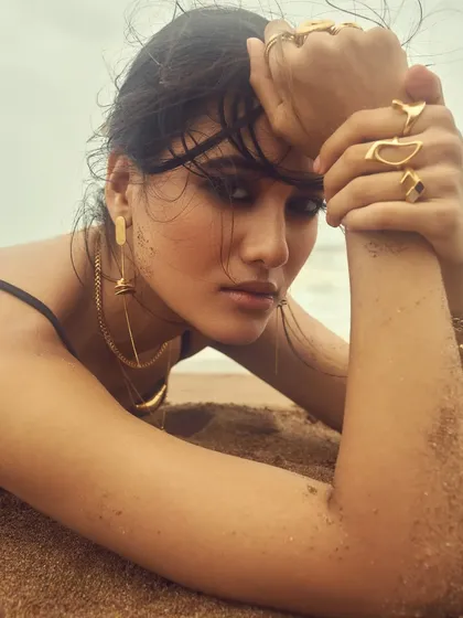 An artistic shot from the beach campaign. The makeup withstands the elements, looking perfect for this sandy, close-up photo.