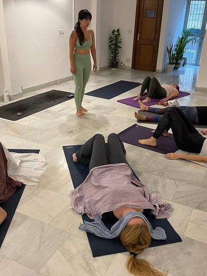 Students resting in Savasana during a breathwork workshop, allowing the transformative effects of the practice to integrate.