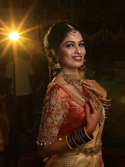 A sun-kissed shot of our bride Sahana. The light catches the antique gold finish of her jewellery, making her glow.